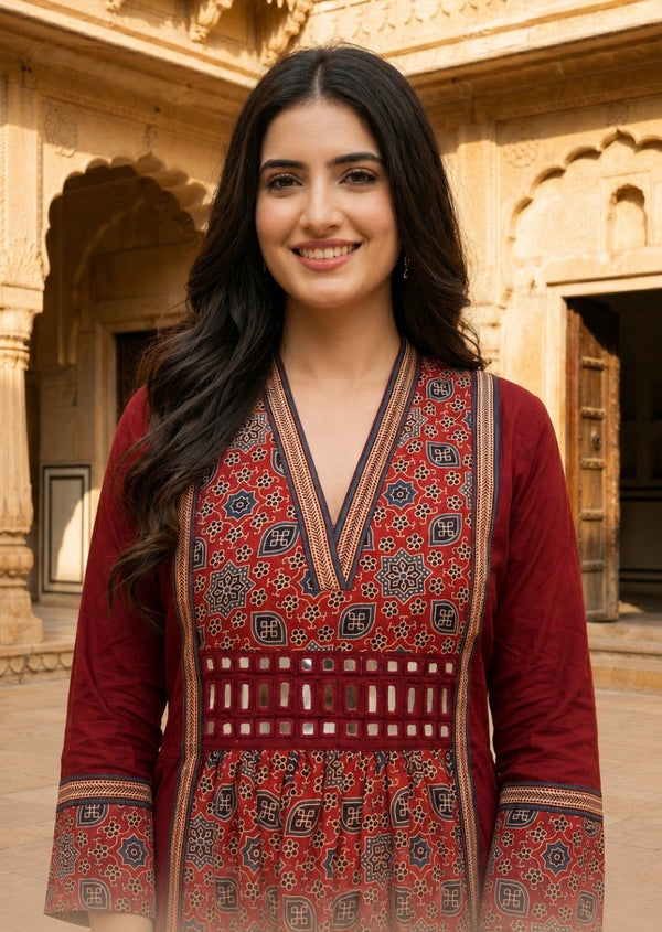 Woman wearing Red Ajrakh print dress with mirror work | Kunvarani
