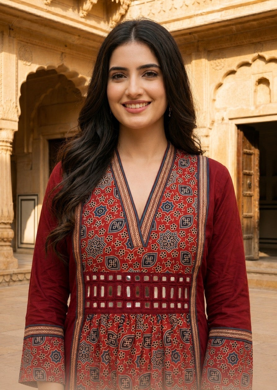 Woman wearing Red Ajrakh print dress with mirror work | Kunvarani