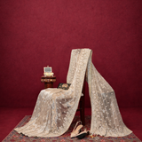 Vintage lace curtain draped over a chair against a red wall